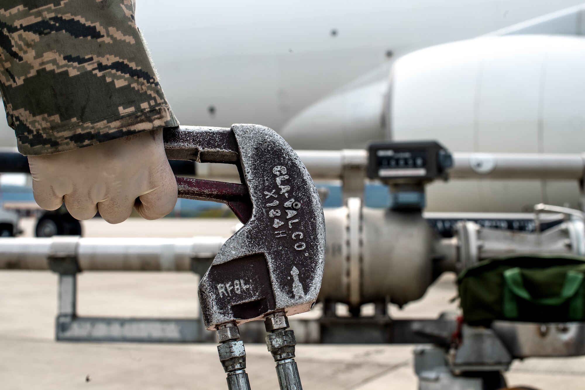 Photo of Airman refueling a jet