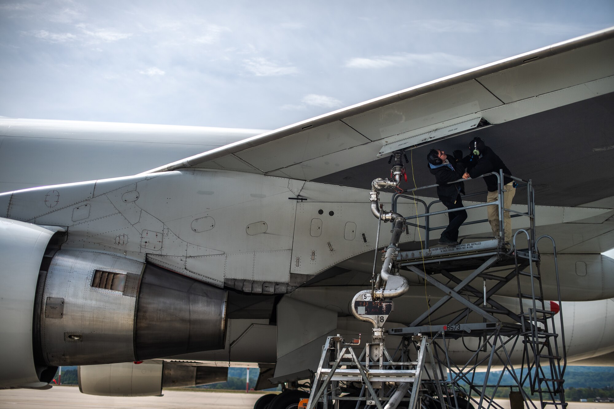 Photo of Airman refueling a jet