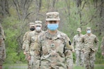 U.S. Army Spc. Kylee Pavlick, combat medic with Headquarters and Headquarters Company, 28th Expeditionary Combat Aviation Brigade, Pennsylvania National Guard, stands in formation. Pavlick works full-time as a nurse at Geisinger Holy Spirit, a hospital near Harrisburg, and is caring for COVID-19 patients.