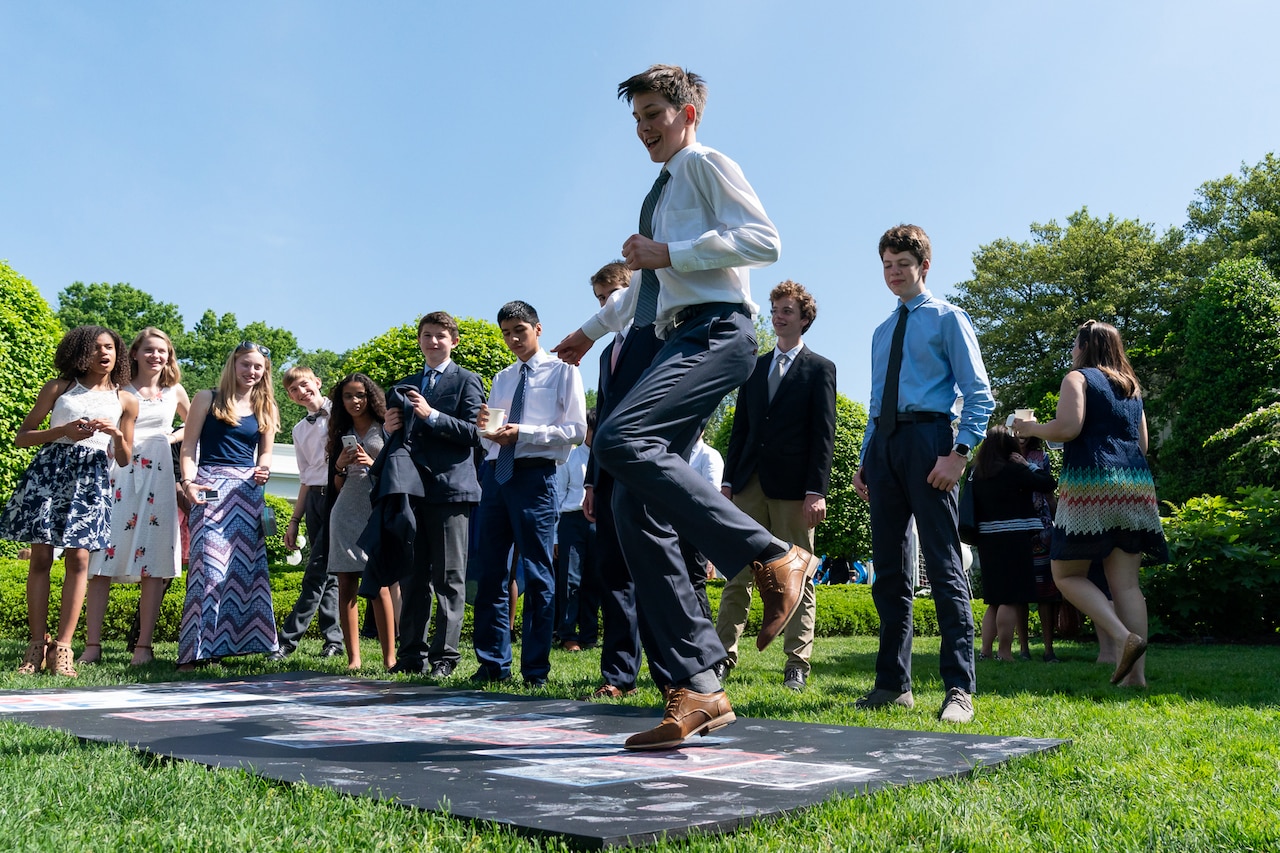 Children play hopscotch.