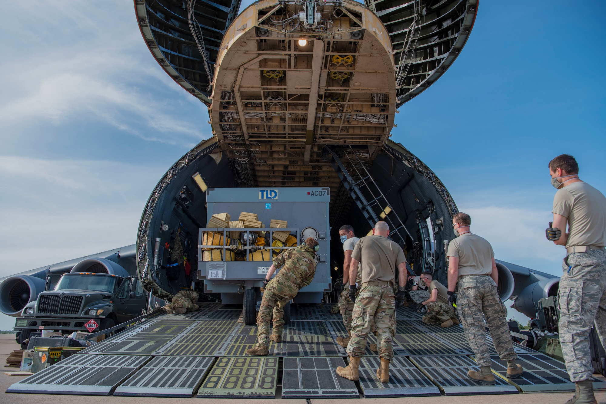 Airmen from the 7th Logistics Readiness Squadron load an air conditioning unit onto a C-5 Galaxy assigned to Dover Air Force Base, Delaware, at Dyess AFB, Texas, April 27, 2020. The C-5 transported Bomber Task Force equipment for four B-1B Lancers and approximately 200 Airmen to Andersen AFB, Guam. The BTF supports Pacific Air Forces' training efforts with allies, partners and joint forces; and strategic deterrence mission to reinforce the rules-based international order in the Indo-Pacific region (U.S. Air Force photo by Airman 1st Class Nicole Molignano)