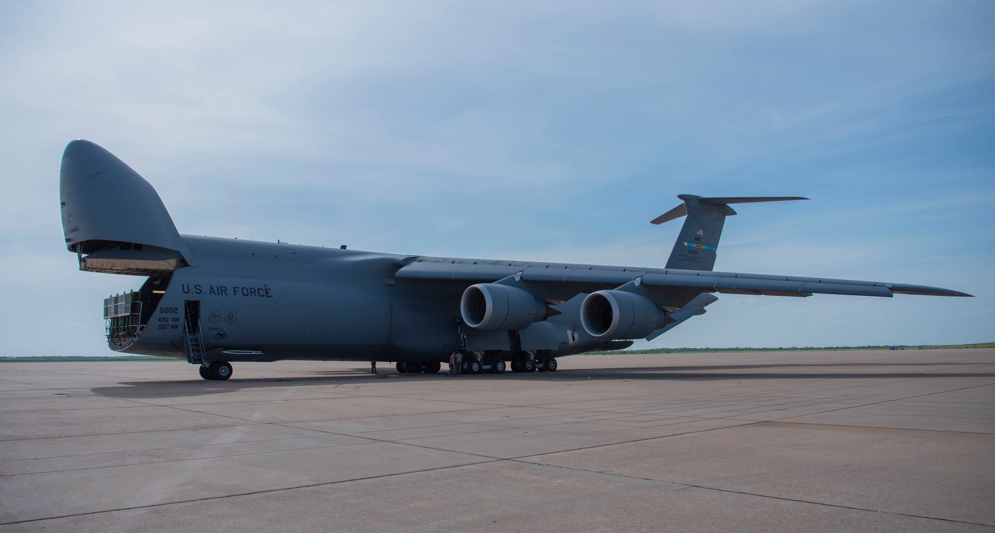 A C-5 Galaxy assigned to Dover Air Force Base, Delaware, is parked on the flightline at Dyess AFB, Texas, April 27, 2020. The C-5 transported Bomber Task Force equipment for four B-1B Lancers and approximately 200 Airmen to Andersen AFB, Guam. The BTF supports Pacific Air Forces' training efforts with allies, partners and joint forces; and strategic deterrence mission to reinforce the rules-based international order in the Indo-Pacific region (U.S. Air Force photo by Airman 1st Class Nicole Molignano)