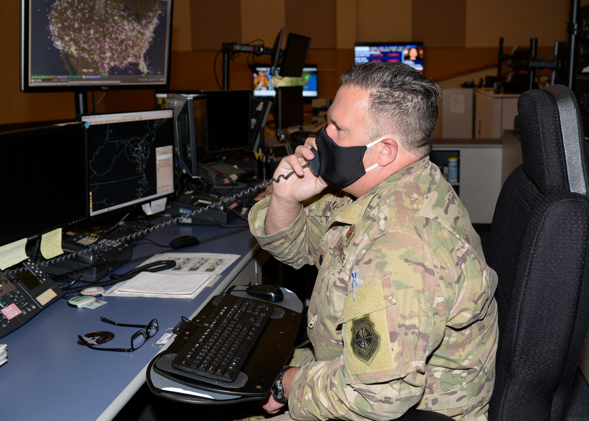 U.S. Air Force Lt. Col. G. Scott Key, senior offensive duty officer, 601st Air Operations Center (AOC), talks on the phone while practicing personal safety protocols due to the current COVID-19 global pandemic at Tyndall Air Force Base, Florida, May 4, 2020.