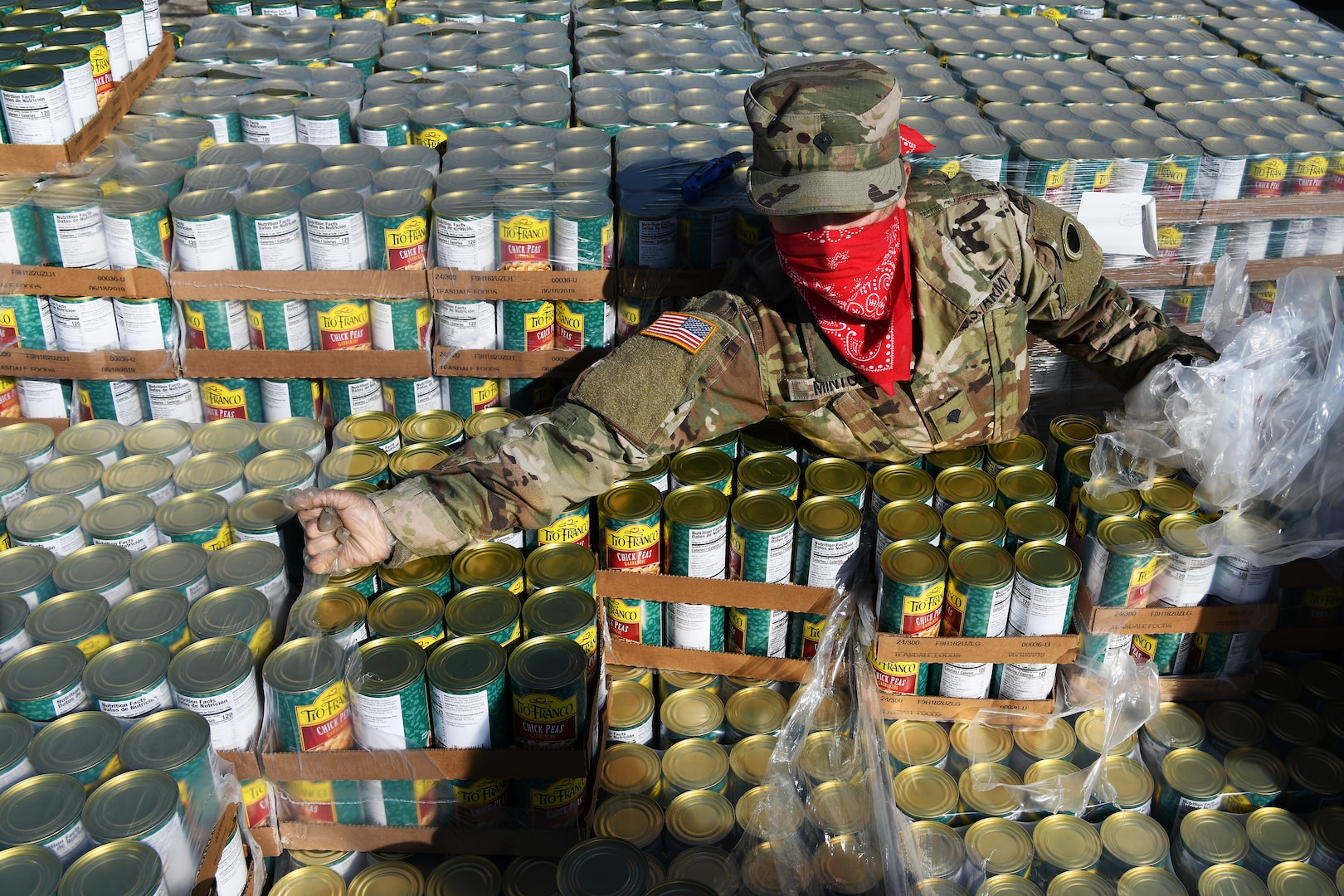 U.S. Army Spc. Rose Minton, a vehicle operator assigned to the Ohio National Guard's 237th Brigade Support Battalion, unpacks pallets of food April 21, 2020, at Wright State University's Nutter Center in Fairborn, Ohio. More than 400 members of the Ohio National Guard were activated March 18, 2020 to support food distribution efforts at 12 locations across Ohio serving more than 11 million Ohioans in all 88 counties.