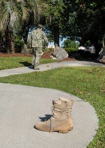 At the conclusion of the change of command ceremony Capt. Aaron S. Peters, who was an all-state wrestler from Ohio and a wrestler for U.S. Naval Academy removed his boots, a time honored tradition for wrestlers retiring from competition.