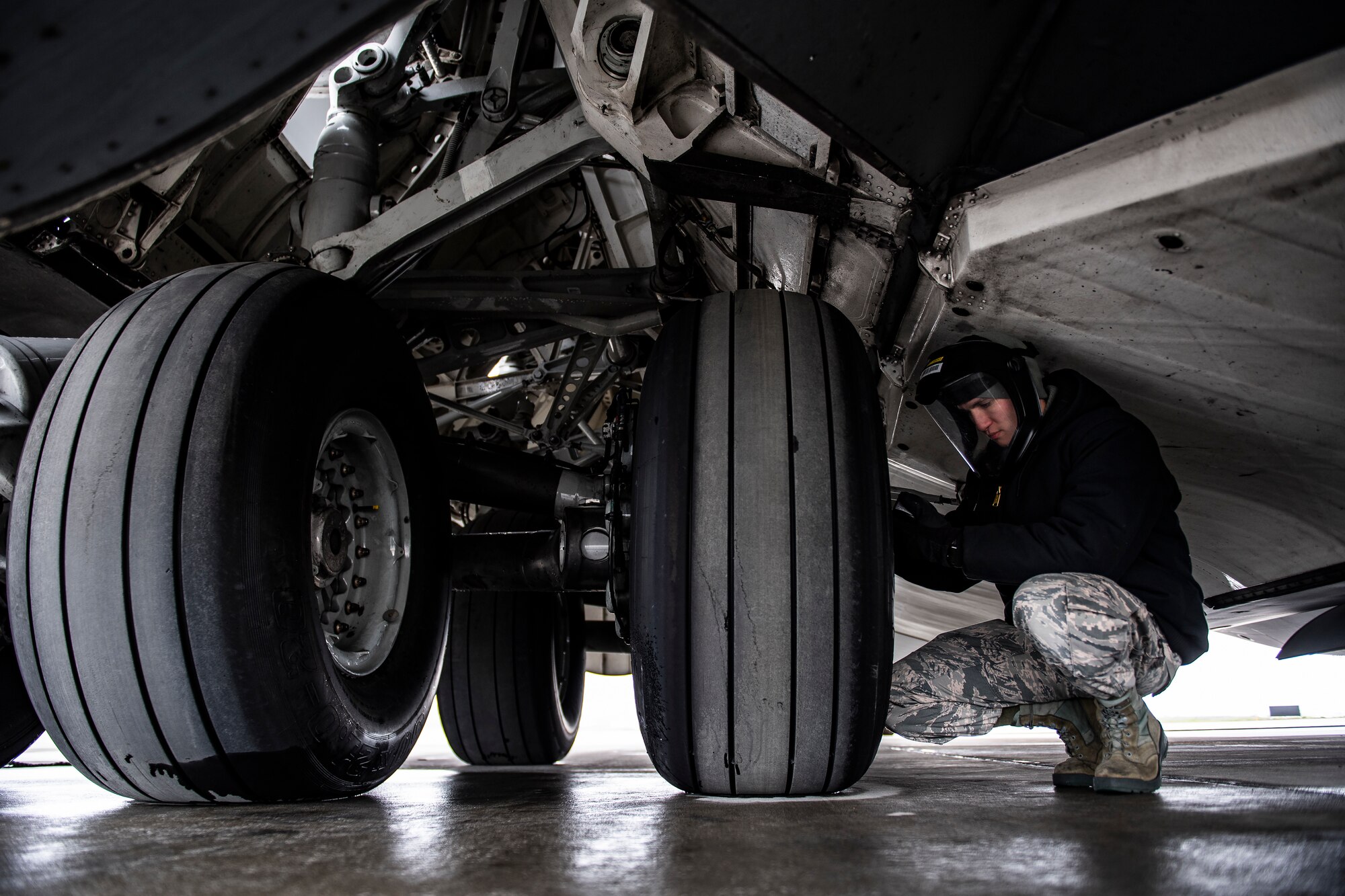Senior Airman checks tire air pressure on a C-17
