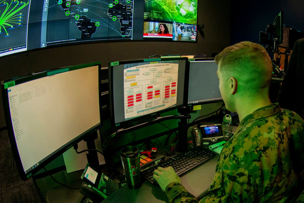 Marine operates computer.