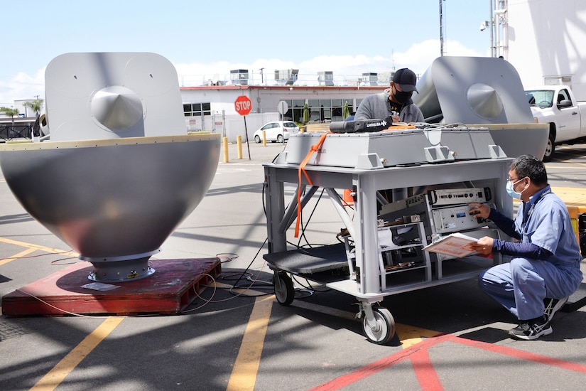 Technicians work on satellite.