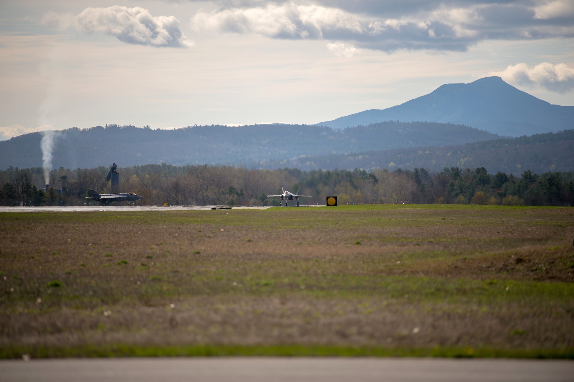 Two F-35 Lightning IIs approach the runway at the Vermont Air National Guard Base.
