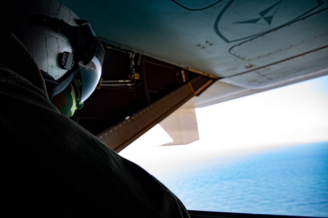 A U.S. Marine with Marine Medium Tiltrotor Squadron 268, Marine Aircraft Group 24, watches from the rear of an MV-22B Osprey, Oahu, Hawaii, Marine Corps Base Hawaii, May 5, 2020. The squadron conducted escort lane training with live-fire to better familiarize the crew and promote interoperability between the squadron and MAG-24 squadrons. (U.S. Marine Corps photo by Sgt. Alex Kouns)