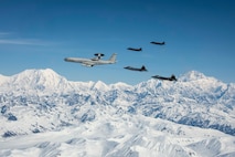 An E-3 Sentry, two F-22 Raptors and two F-35A Lightning IIs fly over Alaska May 5, 2020.