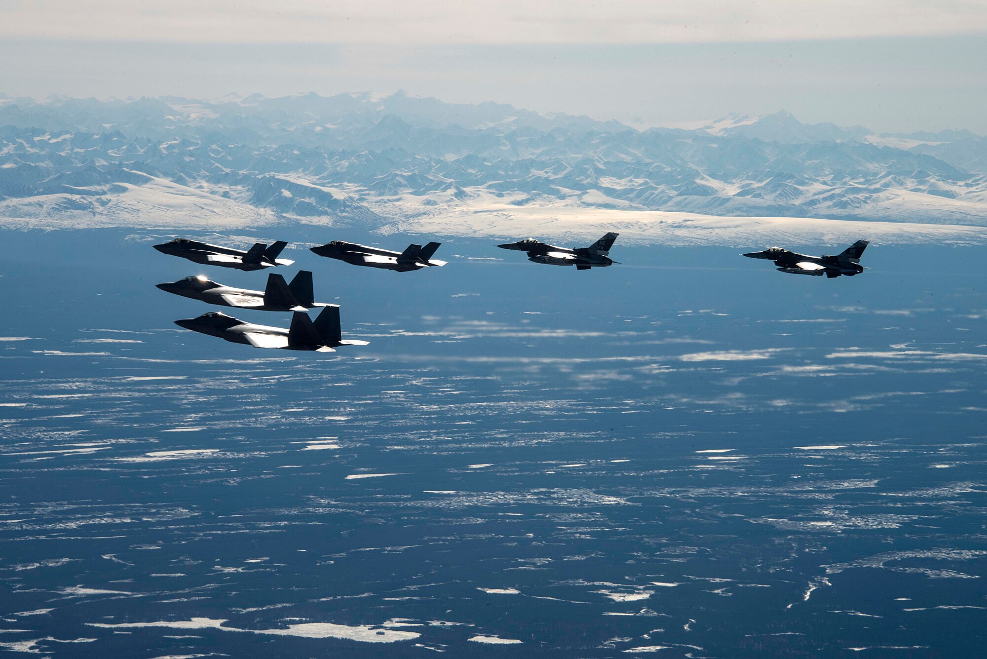 Two F-35A Lightning IIs and two F-16 Fighting Falcons assigned to Eielson Air Force Base fly alongside two F-22 Raptors assigned to Joint Base Elmendorf-Richardson as part of a mass formation flight May 5, 2020.
