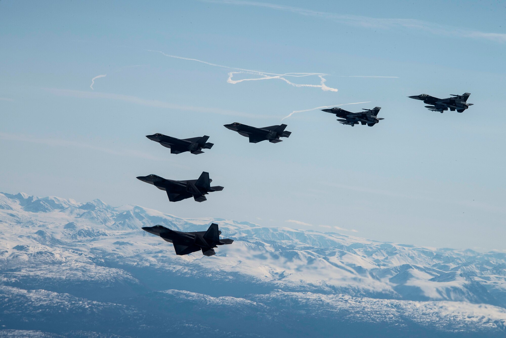 Two F-35A Lightning IIs and two F-16 Fighting Falcons assigned to Eielson Air Force Base fly alongside two F-22 Raptors assigned to Joint Base Elmendorf-Richardson as part of a mass formation flight May 5, 2020.