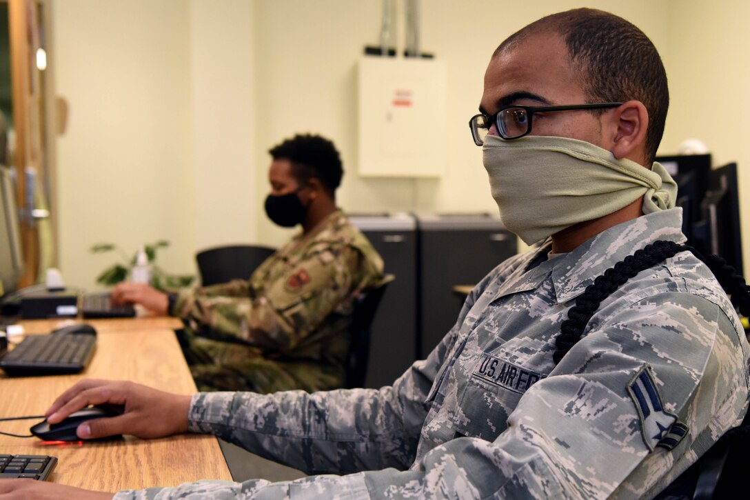 An airman working at a computer.
