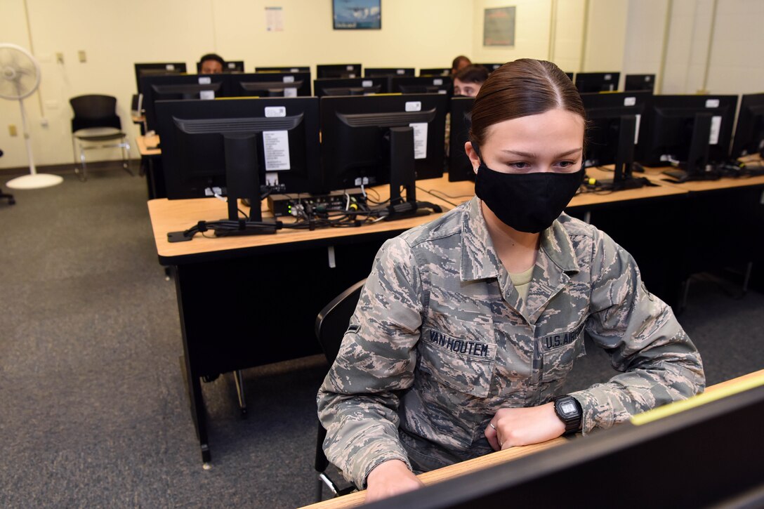 An airman working at a computer.