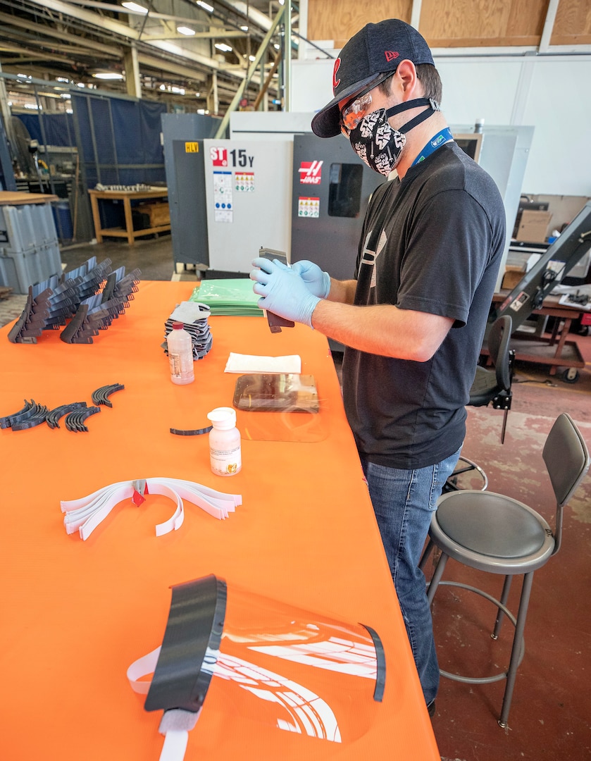 Rico Montalvo, a toolmaker with Shop 31, assembles face shields for use during the COVID-19 outbreak Tuesday, May 5 in Building 431 at Puget Sound Naval Shipyard & Intermediate Maintenance Facility in Bremerton.