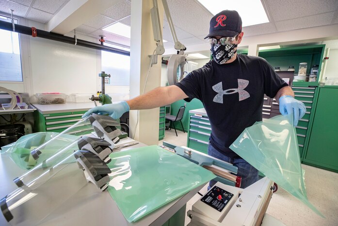 Rico Montalvo, a toolmaker with Shop 31, bags and seals face shields for use during the COVID-19 outbreak Tuesday, May 5 in Building 431 at Puget Sound Naval Shipyard & Intermediate Maintenance Facility in Bremerton.