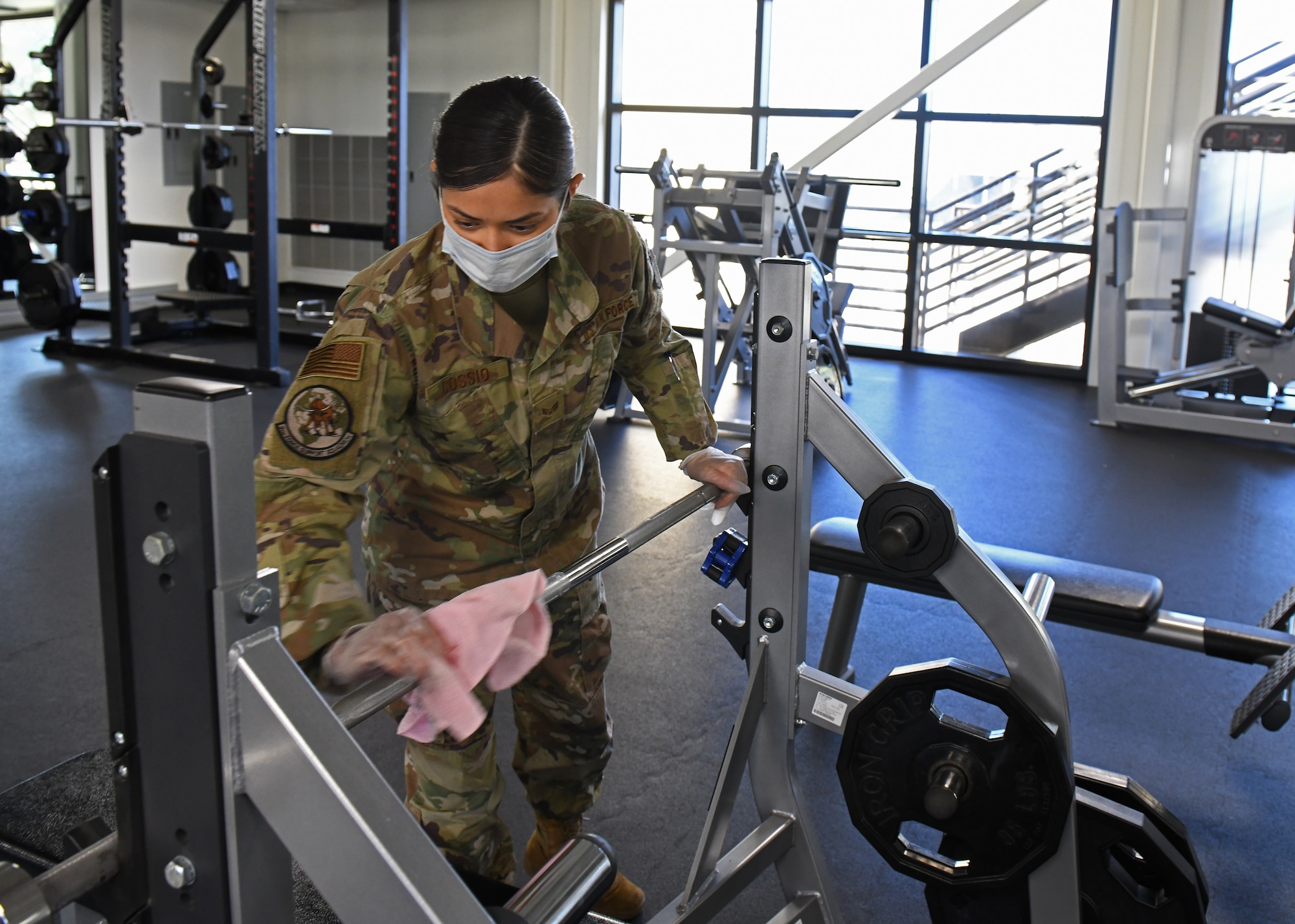 U.S. Air Force Senior Airman Nansi Cossio, 9th Force Support Squadron fitness technician, sanitizes a piece of equipment at the Harris Fitness Center, May 6, 2020, at Beale Air Force Base, California. Every piece of equipment found in the facility was disinfected to ensure the safety and health of the base community from COVID-19. (U.S. Air Force photo by Airman 1st Class Luis A. Ruiz-Vazquez)