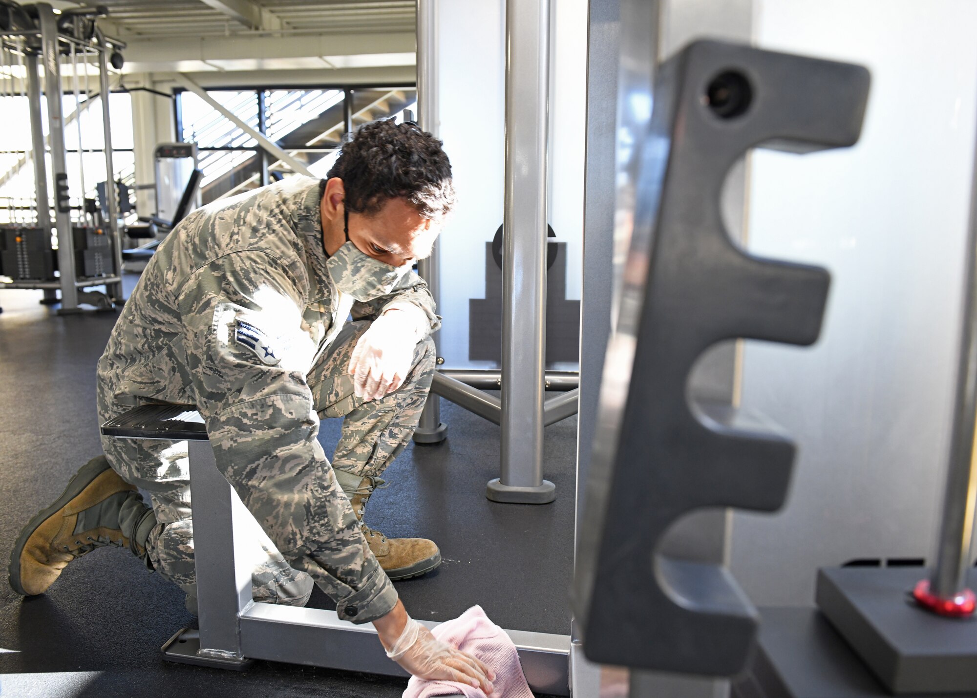 U.S. Air Force Senior Airman Calvin Taylor, 9th Force Support Squadron fitness technician, sanitizes equipment in the Harris Fitness Center at Beale Air Force Base, California, May 6, 2020. The Harris Fitness Center personnel conducted a deep cleaning of the facility in preparation for the reopening on May 11. (U.S. Air Force photo by Airman 1st Class Luis A. Ruiz-Vazquez)