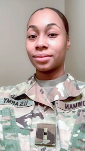 Black female in green camouflage uniform.