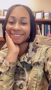 Black female in green camouflage uniform.