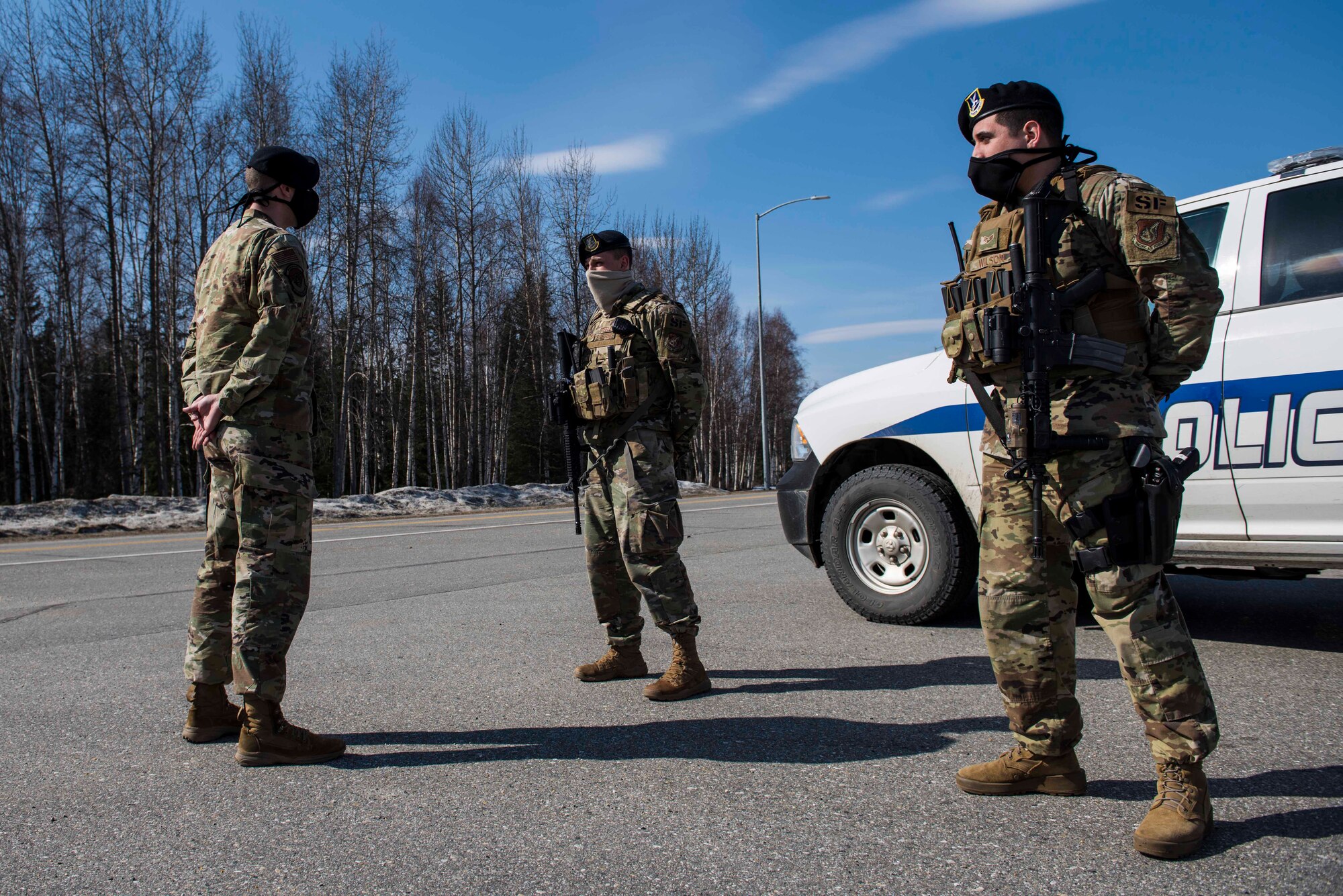 U.S. Air Force Tech. Sgt. Matthew R. Dobbins, the 354th Security Forces Squadron (SFS) non-commissioned officer in charge of operations, performs a post briefing with Senior Airman Cole Steele and Senior Airman Justin Wilson, 354th SFS response force officers, at Eielson Air Force Base, Alaska, April 28, 2020.