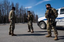 U.S. Air Force Tech. Sgt. Matthew R. Dobbins, the 354th Security Forces Squadron (SFS) non-commissioned officer in charge of operations, performs a post briefing with Senior Airman Cole Steele and Senior Airman Justin Wilson, 354th SFS response force officers, at Eielson Air Force Base, Alaska, April 28, 2020.
