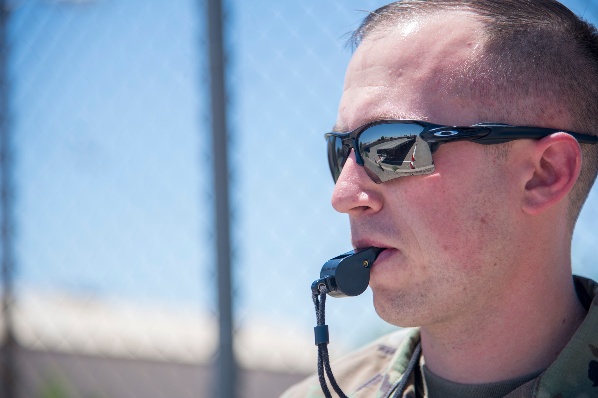 Staff Sgt. Cody Small, 49th Logistics Readiness Squadron training validation and operations noncommissioned officer in charge, blows a whistle during an American Association for Motor Vehicle Administrator/Commercial Driver License certification test, March 6, 2020, on Holloman Air Force Base, N.M. Only trained and appointed training validation and operation examiners can certify personnel on the four-part AAMVA/CDL qualification test compromised of a written multiple-choice test, a vehicle inspection, a basic control skills test and a road test. (U.S. Air Force photo by Senior Airman Collette Brooks)