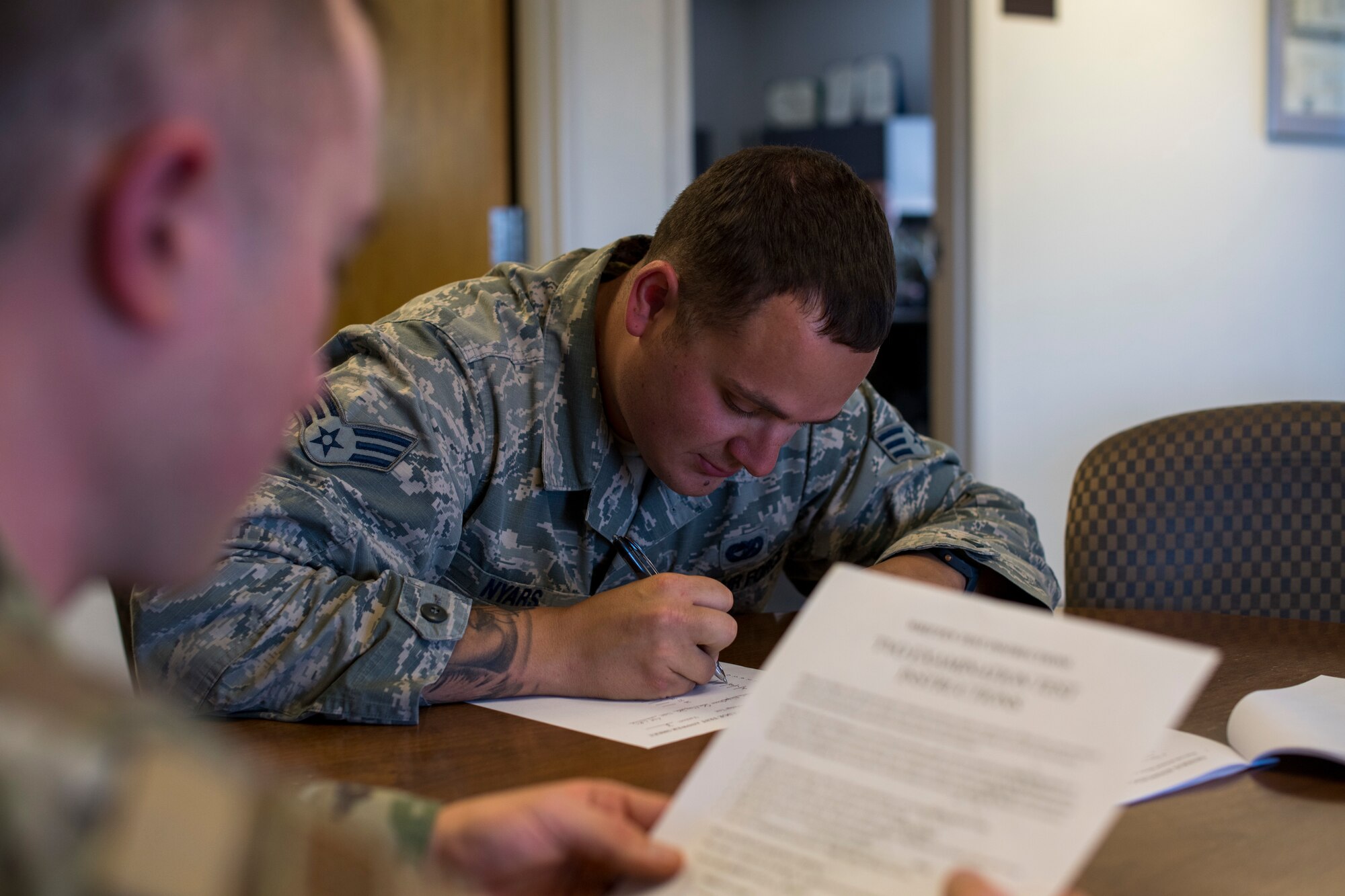 Senior Airman Ryan Nyars, 49th Logistic Readiness Squadron ground transportation trainer, takes an American Association for Motor Vehicle Administrator/Commercial Driver License certification written test, March 6, 2020, on Holloman Air Force Base, N.M. Only trained and appointed training validation and operation examiners can certify personnel on the four-part AAMVA/CDL qualification test compromised of a written multiple-choice test, a vehicle inspection, a basic control skills test and a road test. (U.S. Air Force photo by Senior Airman Collette Brooks)