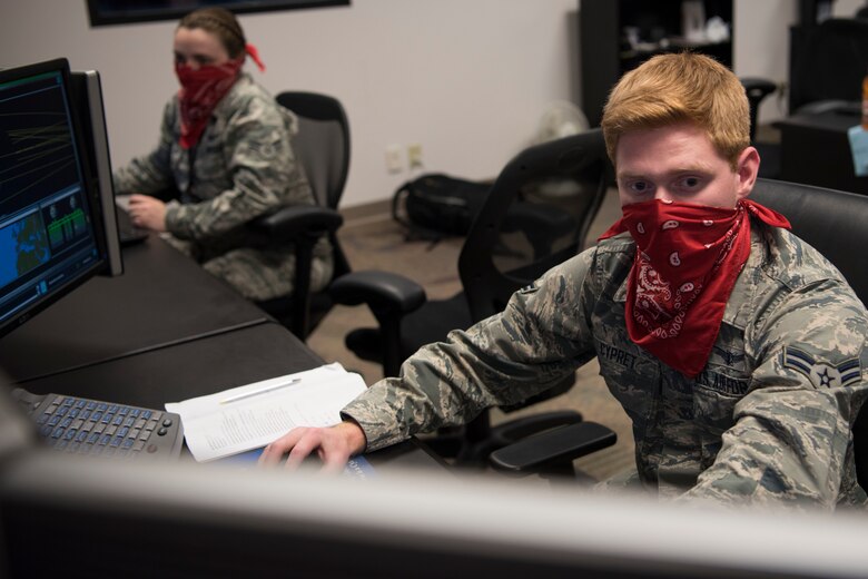 Airman 1st Class Brayden Cypret, 50th Operations Support Squadron student, practices  anomaly resolution actions May 7, 2020, at Schriever Air Force Base, Colorado. The 50th OSS continues to train space warfighters despite the ongoing pandemic. While training under these conditions, Airmen must wear a facemask and remain six feet apart. (U.S. Air Force photo by Airman 1st Class Jonathan Whitely)