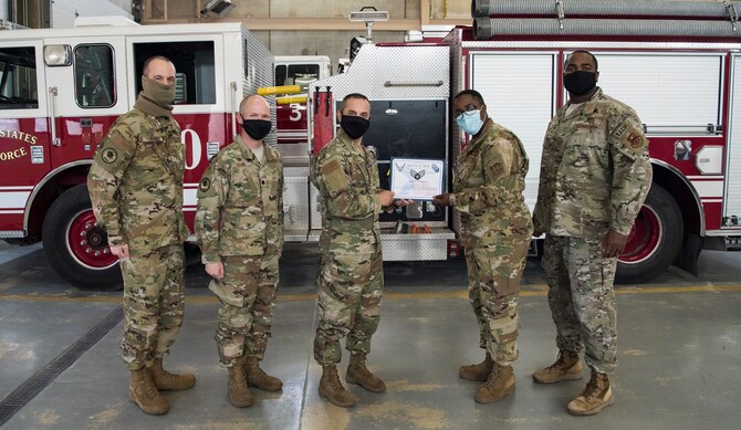 Col. Lee Gentile, 47th Flying Training Wing commander, and Chief Master Sgt. Robert L. Zackery III, 47th Command Chief, present Airman 1st Class Joquetta K. Rolle, a 47th Civil Engineer Squadron firefighter, with her Senior Airman Below-the-Zone certificate on May 8, 2020, at Laughlin Air Force Base, Texas. Rolle was selected to promote to the rank of Senior Airman six months ahead of her peers. (U.S. Air Force photo by Senior Airman Marco A. Gomez)