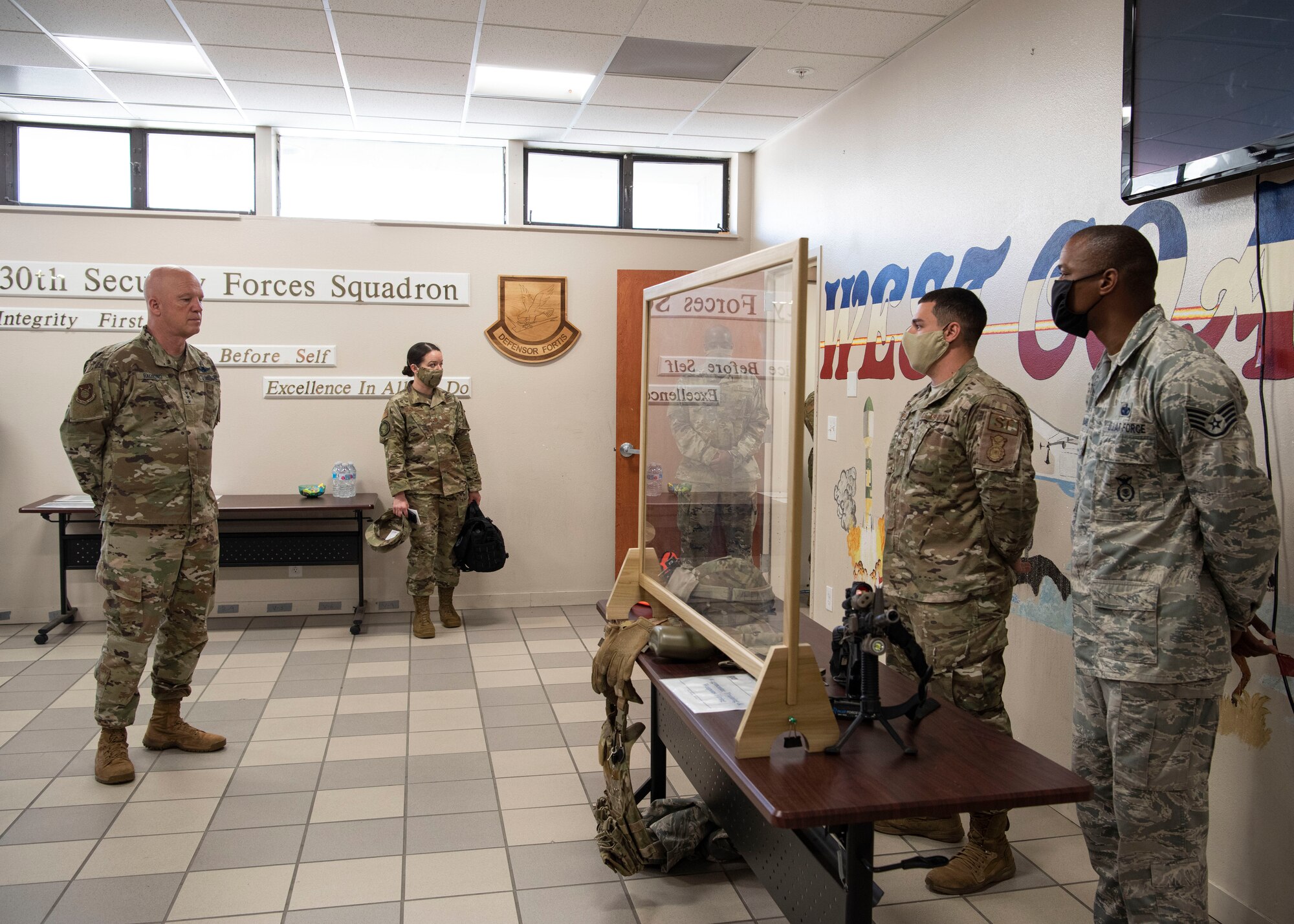 Members of 30th Security Forces Squadron, brief Gen. Jay Raymond, U.S. Space Force Chief of Space Operations and U.S. Space Command commander, on the implementation of an augmentee training program to sustain operations during COVID-19, May 7, 2020, at Vandenberg Air Force Base, Calif. During the visit, Raymond observed and commended the members of Vandenberg AFB for their response to the COVID-19 global pandemic. (U.S. Air Force photo by Senior Airman Aubree Owens)