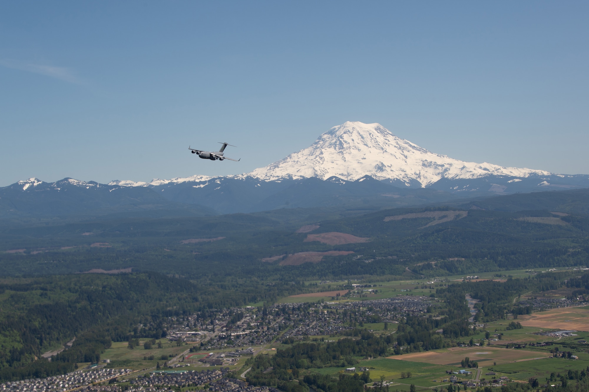 A C-17 Globemaster III assigned to the 62nd Airlift Wing conducts an Air Force Salutes morale flyover across the Puget Sound region, May 8, 2020. The flyover honored the American heroes at the forefront in the fight against COVID-19. (U.S. Air Force photo by Senior Airman Sara Hoerichs)