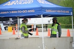 Members of the Iowa National Guard’s 185th Air Refueling Wing at the entrance of the Sioux City, Iowa COVOD-19 “Test Iowa” site help motorists through the test line in the parking lot of the Western Iowa Technical Community College campus on May 7, 2020.