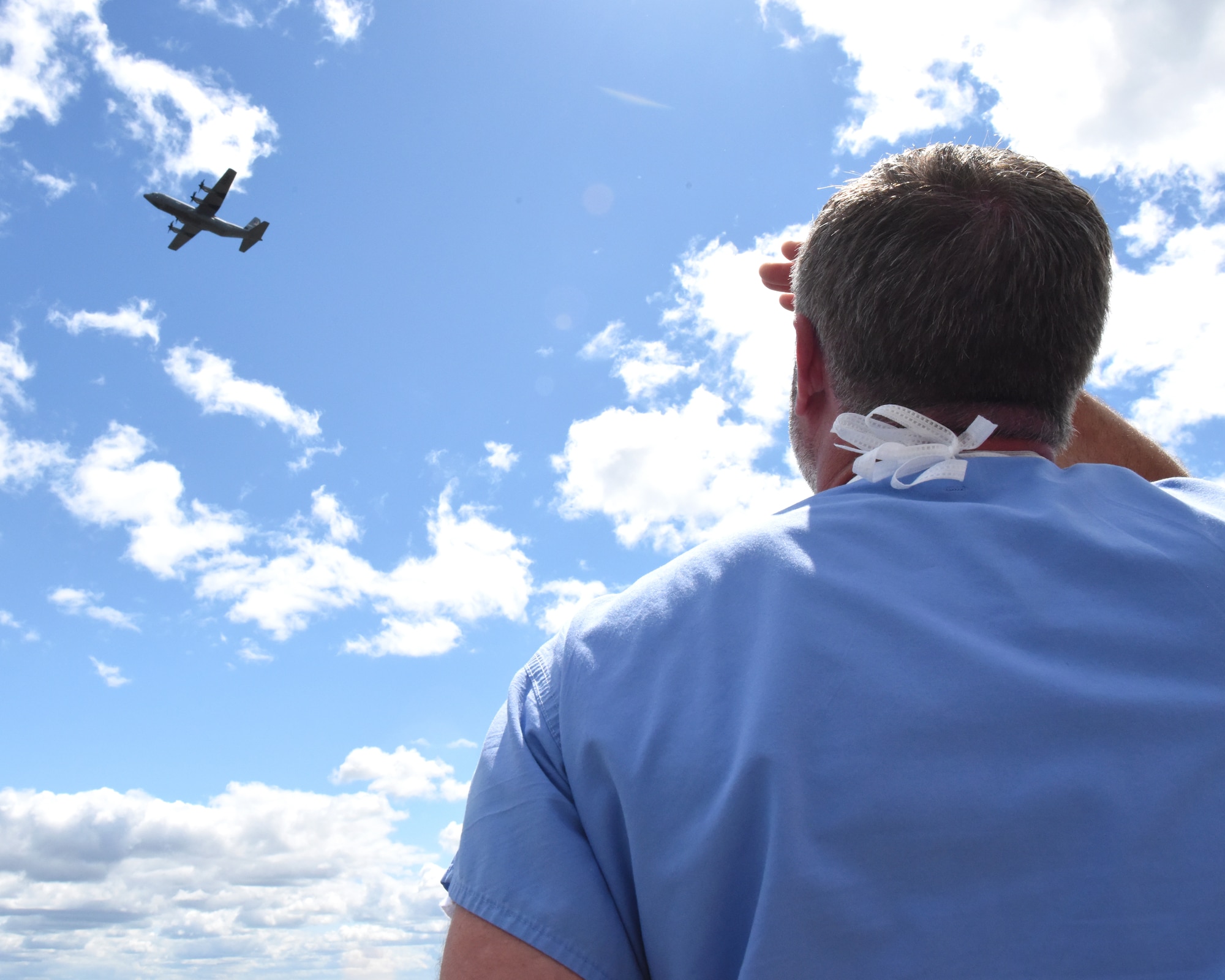 Two C-130s fly over the city