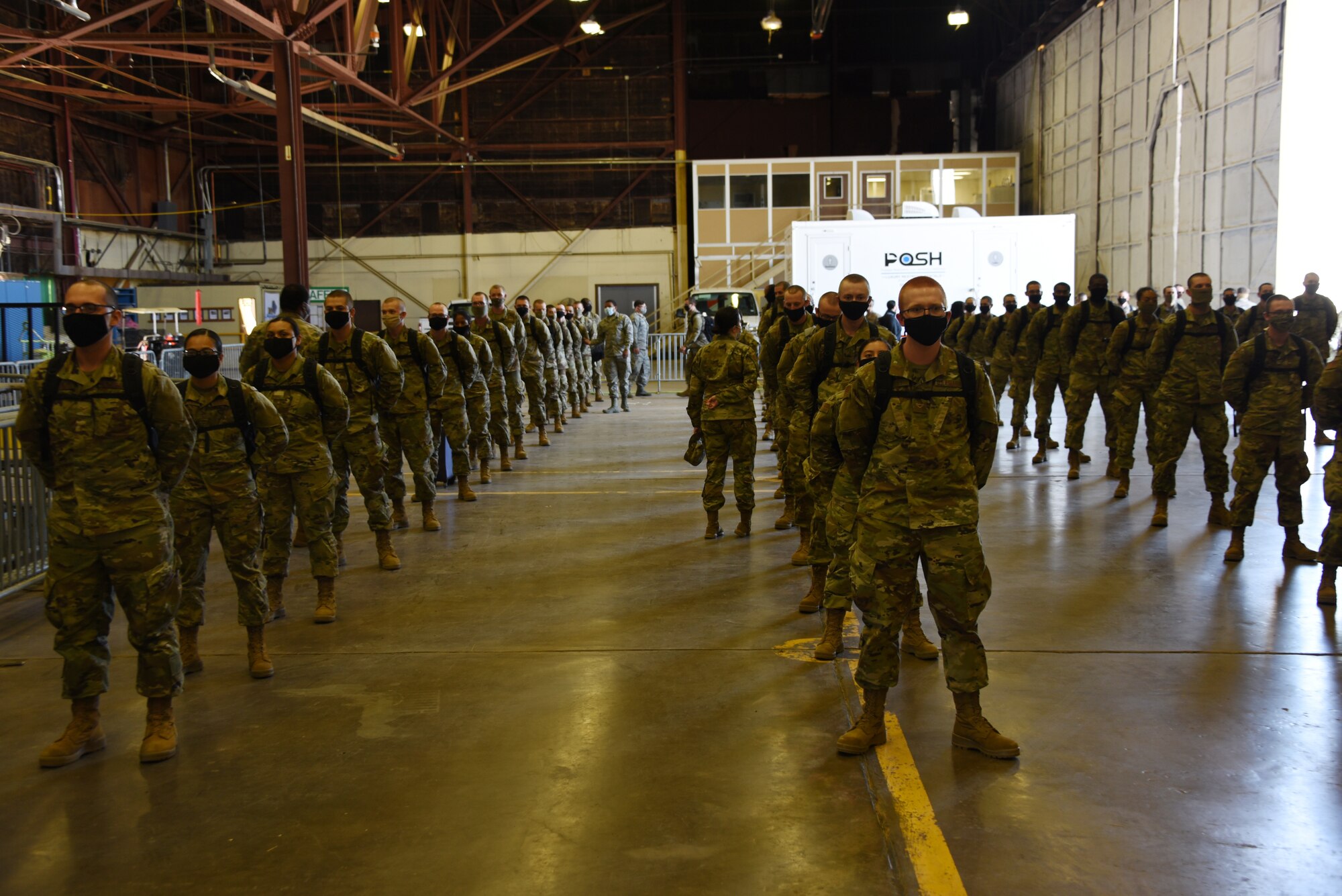 Members of the 82nd Medical Group medically screen Airmen that recently flew in to Sheppard Air Force Base, Texas, on May 8, 2020. The Airmen stand in what is called passenger terminal. The passenger terminal was set up to be able to ensure the health and safety of Airmen in the contingency environment. Typically, freshly graduated Airmen are bussed in from Lackland AFB to attend technical training here. Due to the COVID-19 pandemic, Airmen are being flown in to avoid any contamination during the trip. (U.S. Air Force photo by Staff Sgt. Robert L. McIlrath)