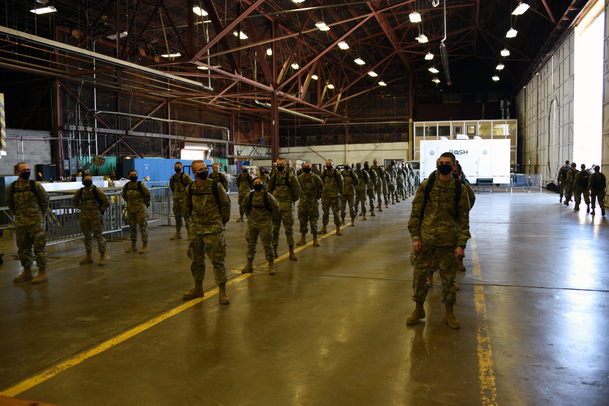 Newly minted Airmen arrive to Sheppard Air Force Base, Texas from Lackland AFB, Texas, after completing basic military training, May 8, 2020. The Airmen stand in what is called passenger terminal. The passenger terminal was set up to be able to ensure the health and safety of Airmen in the contingency environment. Typically, freshly graduated Airmen are bussed in from Lackland AFB to attend technical training here. Due to the COVID-19 pandemic, Airmen are being flown in to avoid any contamination during the trip. (U.S. Air Force photo by Staff Sgt. Robert L. McIlrath)