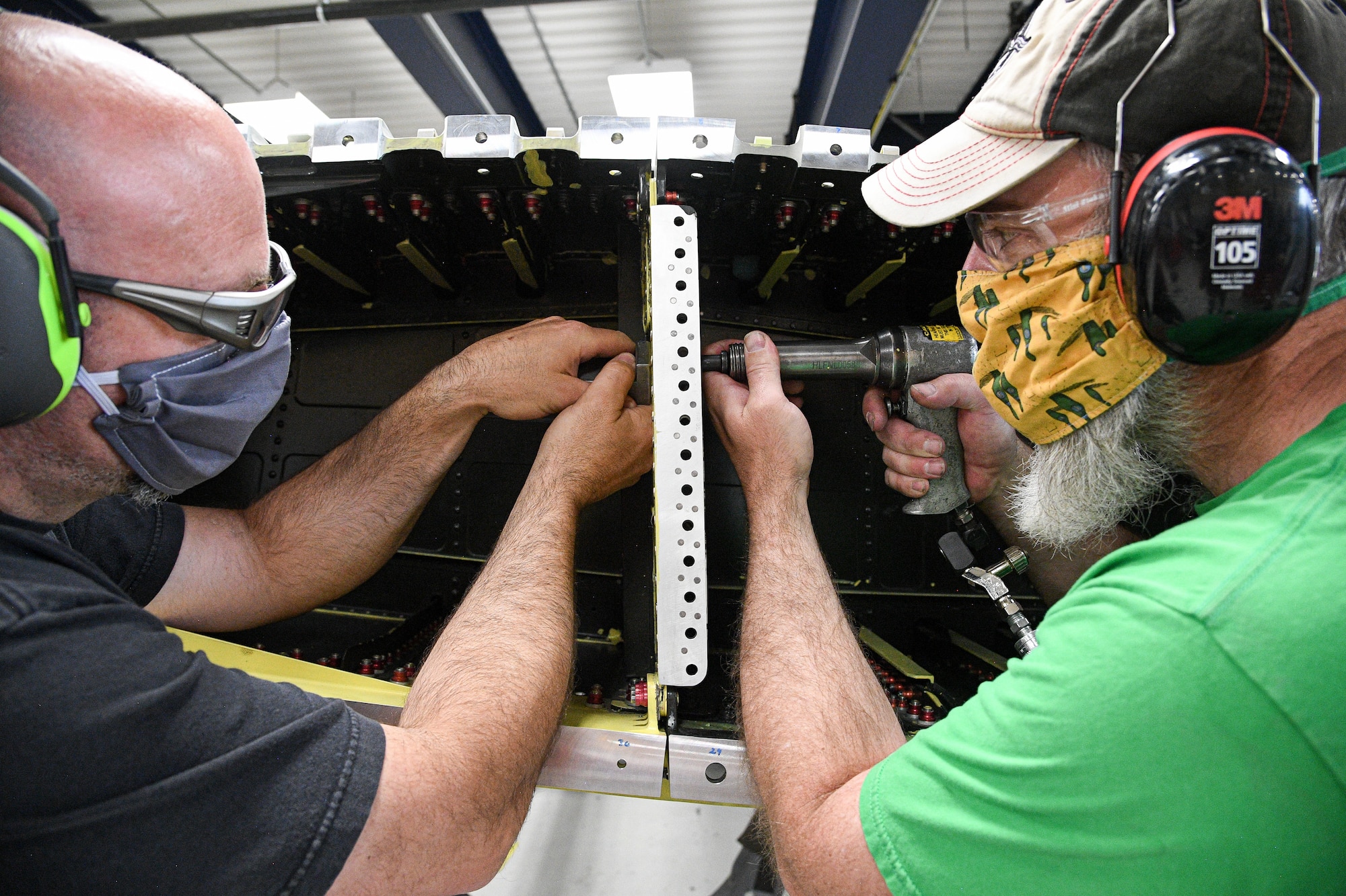 Matt Sheffeld (left) and Wesley Caldwell, 309th Commodities Maintenance Group, install rivets on an A-10 center wing.