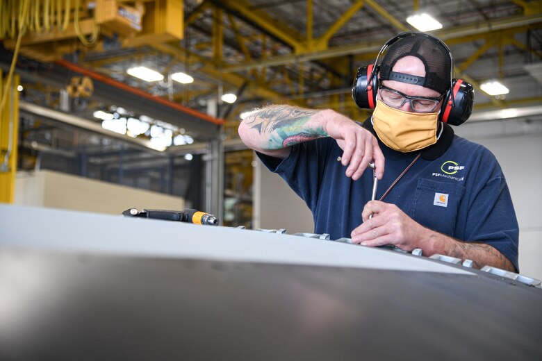 Troy Pattillo, 309th Commodities Maintenance Group sheet metal mechanic, works on an A-10 outer wing.