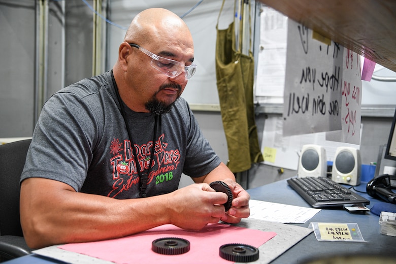 Jamie Garcia, 309th Commodities Maintenance Group, inspects A-10 starter components.