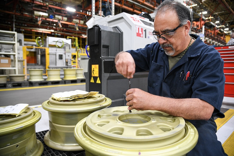 Curtiz Prieto, 309th Commodities Maintenance Group machinist, works on an F-35 wheel.
