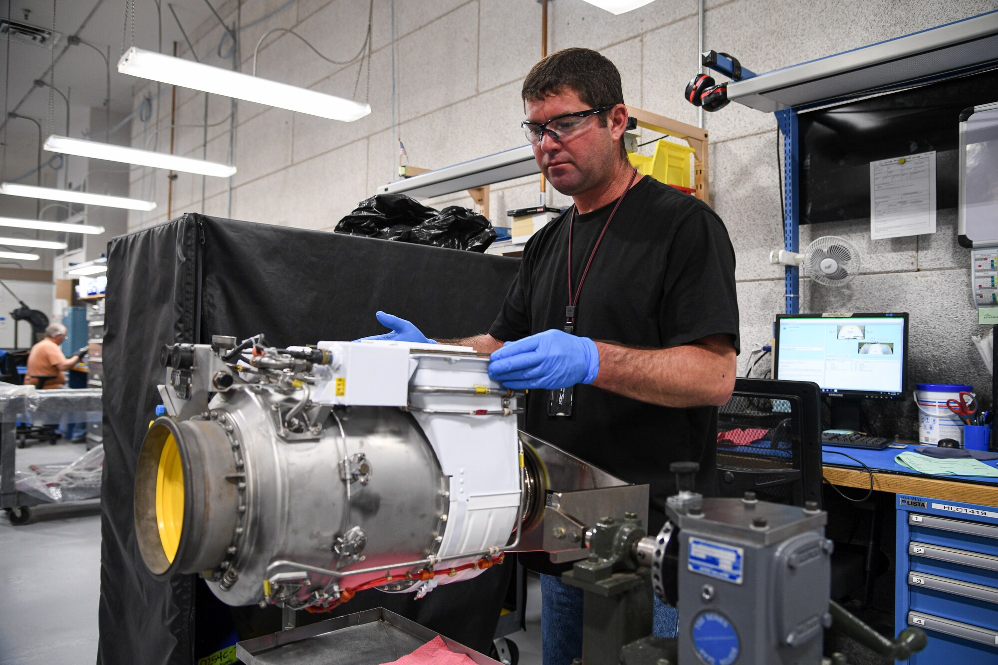 Chris Gardner, 309th Commodities Maintenance Group, works on an F-16 fuel system assembly.