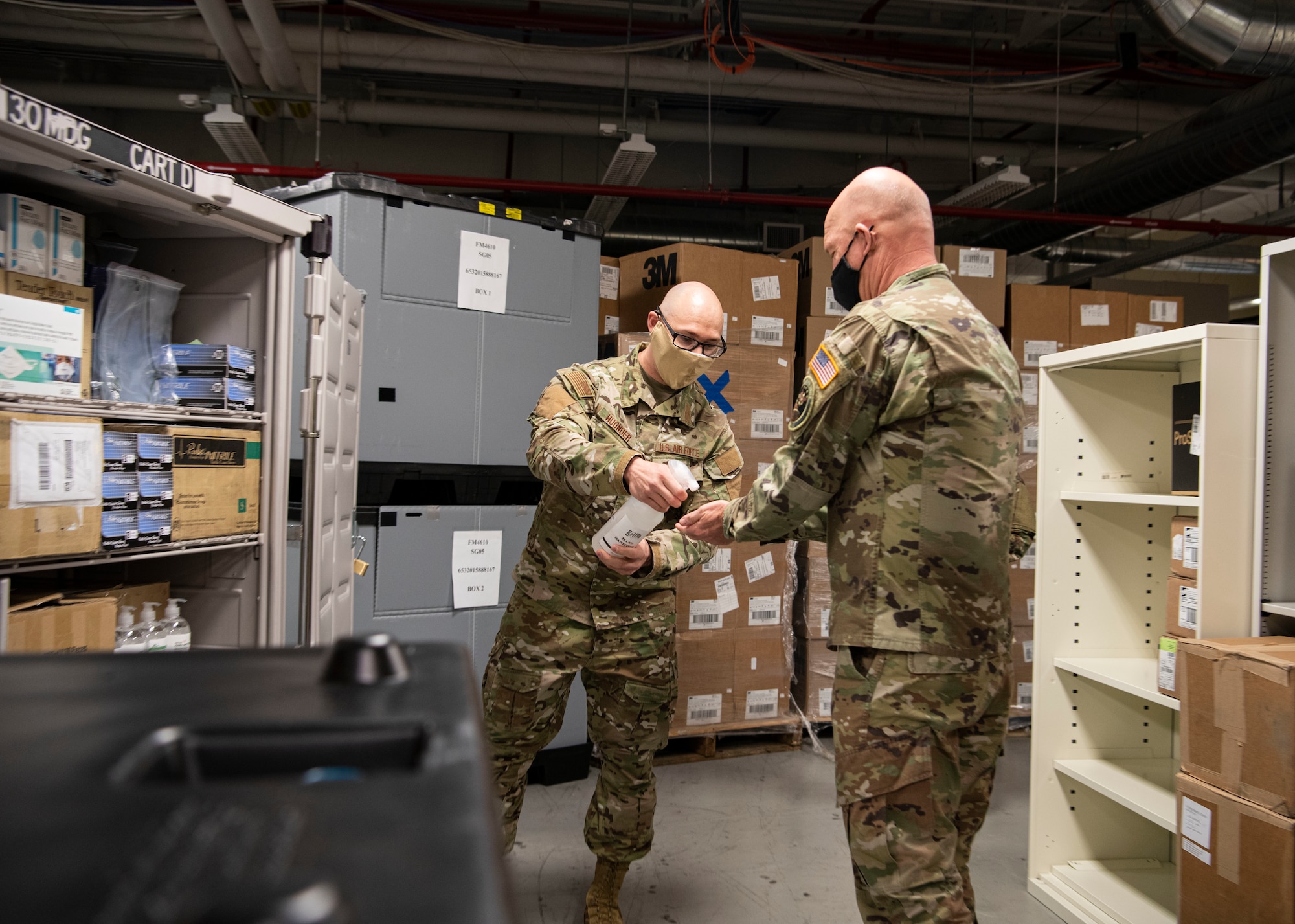 Airman First Class Nicholas Huonder, 30th Medical Group medical logistics technician, sprays hand sanitizer onto the hands of Gen. Jay Raymond, U.S. Space Force Chief of Space Operations and U.S. Space Command commander, May 7, 2020, at Vandenberg Air Force Base, Calif. Huonder sprayed hand sanitizer on Raymond’s hands to showcase the quality of the product during the tour of the 30th MDG where Raymond was briefed on the ongoing efforts put forth in response to the COVID-19 global pandemic.  (U.S. Air Force photo by Senior Airman Aubree Owens)