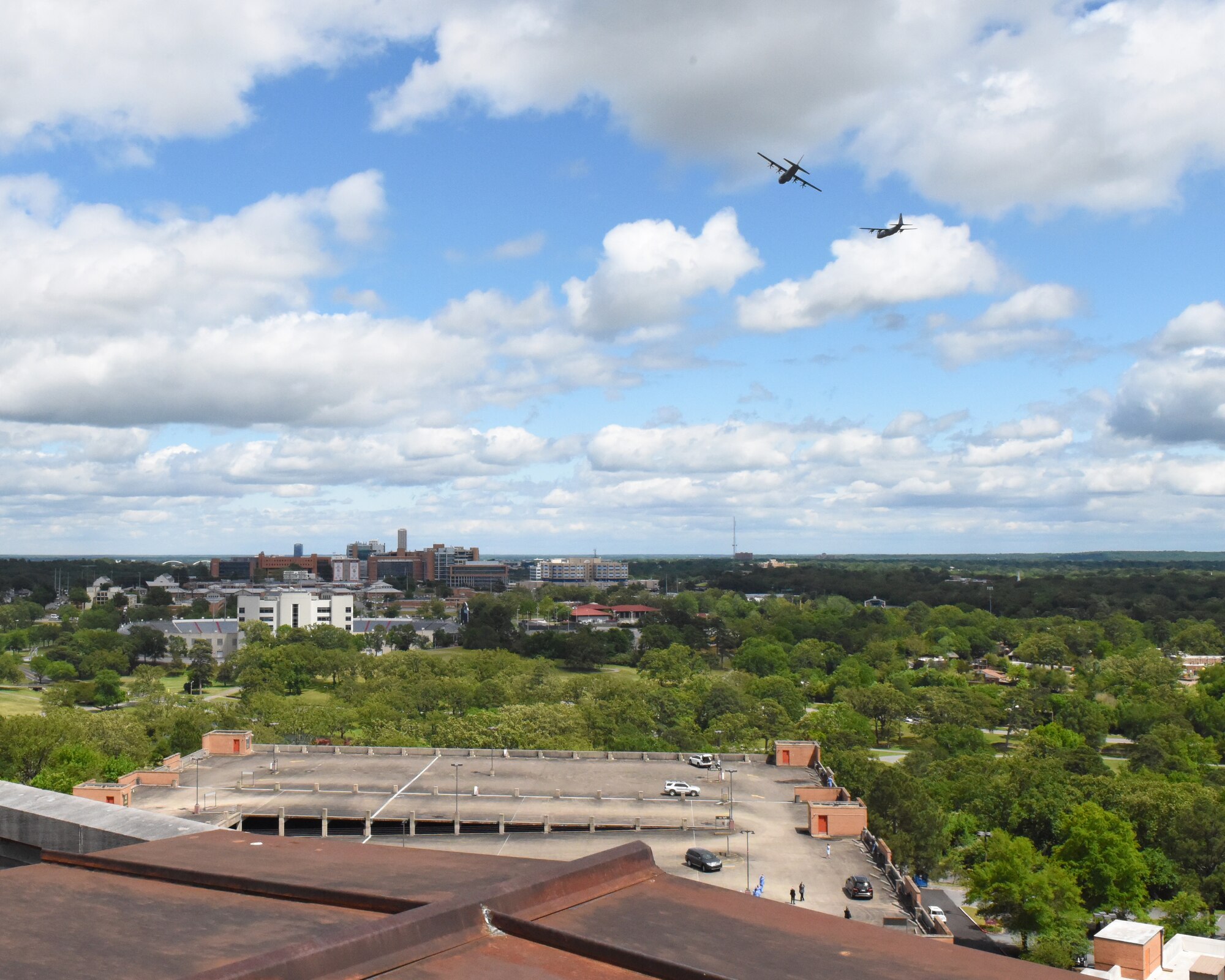Two C-130s fly over the city
