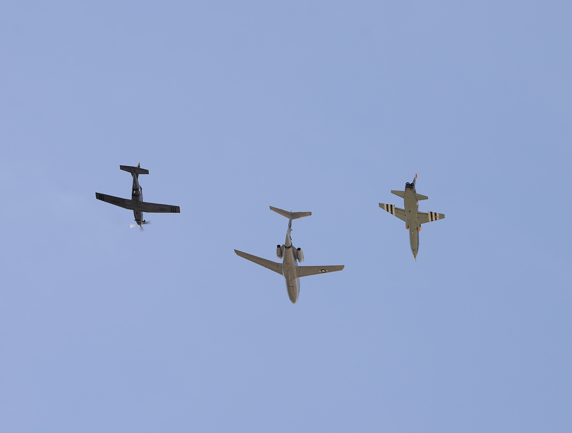 A dissimilar formation of aircraft from Columbus Air Force Base, Miss., fly over The Koritz Clinic. on May 9, 2020. The flyover was an opportunity to honor the men and women on the front lines in the fight against COVID-19 during the Defense Department’s #AmericaStrong salute. The flyover consisted of the T-6A Texan II, T-1A Jayhawk and the T-38 Talon. (U.S. Air Force photo by Airman 1st Class Hannah Bean)