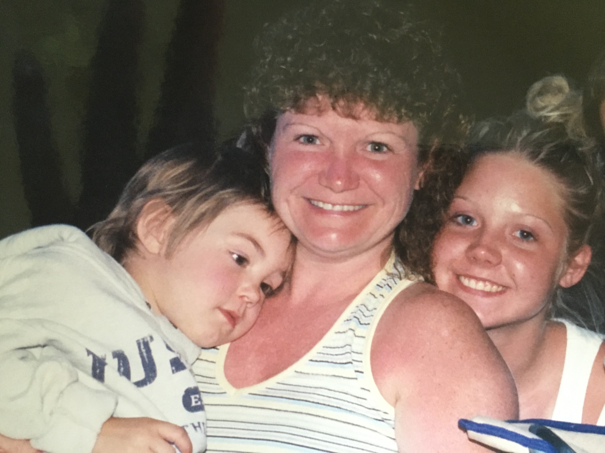 A mother poses with two girls.