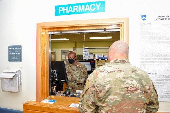U.S. Air Force Maj. Alexander Brown, 8th Medical Support Squadron chief of pharmacy, leads a patient through a series of review questions before distributing medication at Kunsan Air Base, Republic of Korea, May 6, 2020. The pharmacy team provides multiple screening processes of medication and medical history to ensure patient safety. (U.S. Air Force photo by Tech. Sgt. Joshua Arends)