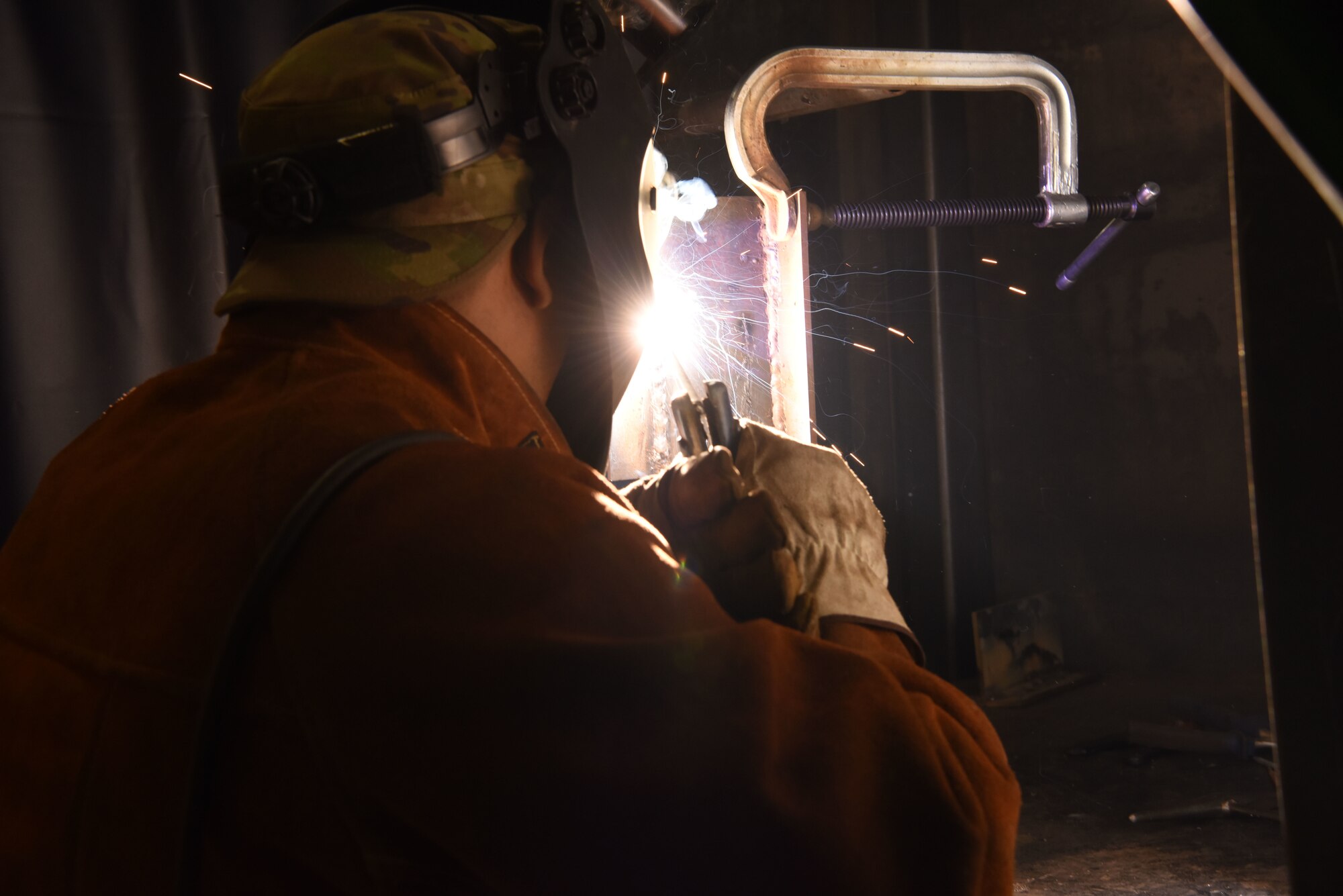 U.S. Air Force Staff Sgt. Israel Gutierrez, 786th Civil Engineer Squadron lock shop noncommissioned officer in charge, fuses metal during a welding course.