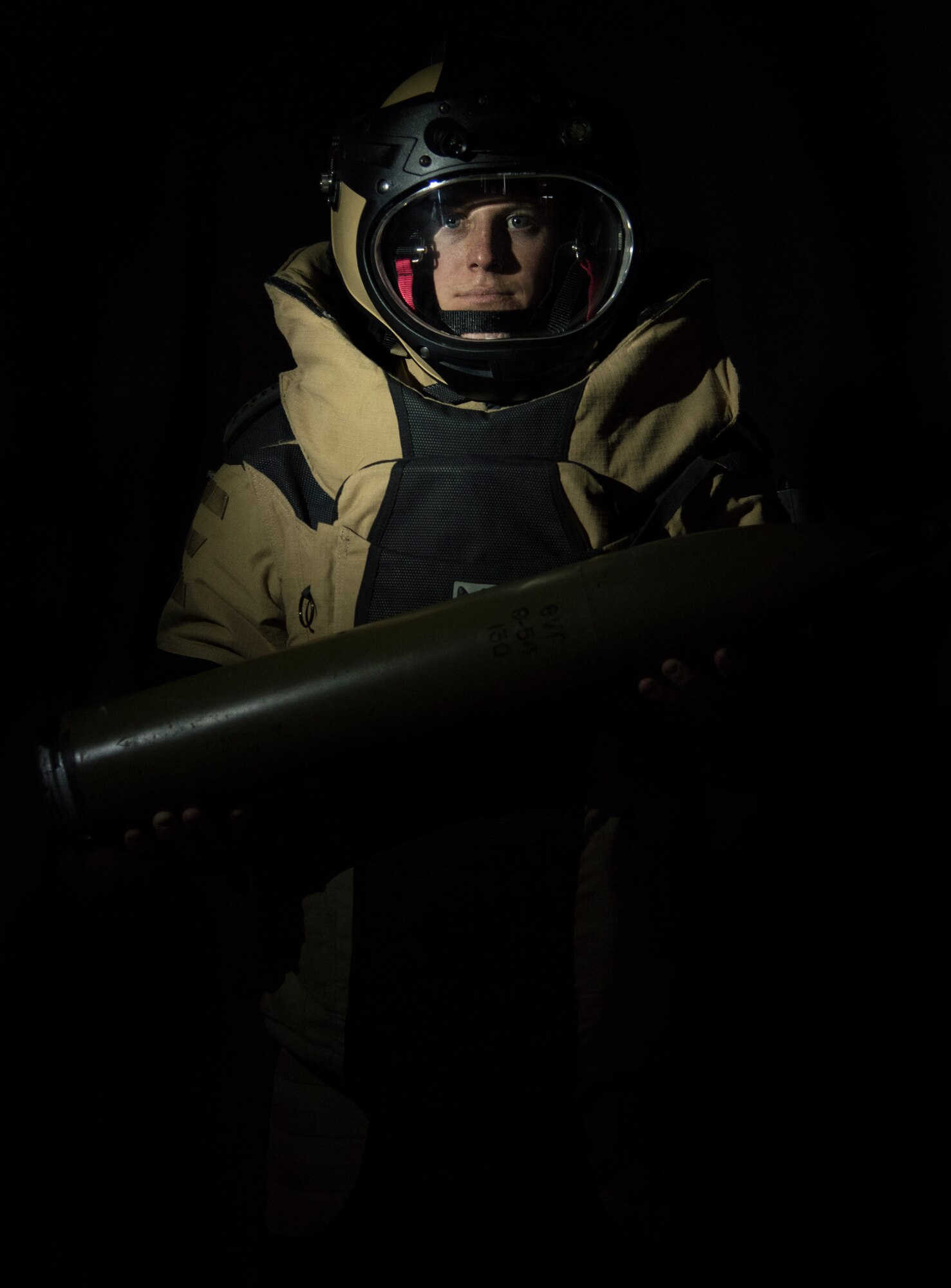 U.S. Air Force Staff Sgt. Michael Long, 786th Civil Engineer Squadron noncommissioned officer in charge of explosive ordnance disposal operations, wears a Med-Eng EOD 9 Bomb Suit while holding a simulated unexploded ordnance at Ramstein Air Base, Germany, May 6, 2020.