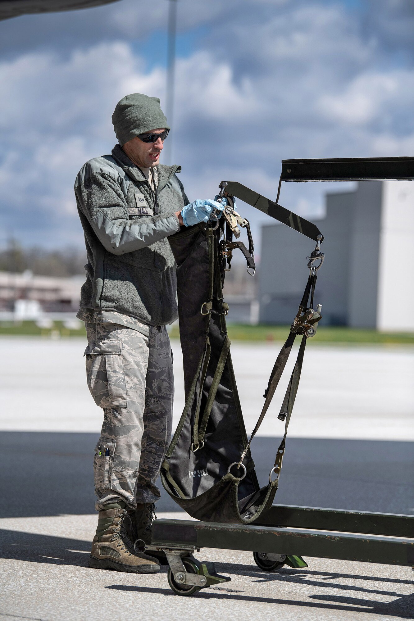 Staff Sgt. Andrew Hall, 445th Aircraft Maintenance Squadron, attaches a C-17 Globemaster III tire onto a hoist here April 9, 2020. 445th Airlift Wing Reservists continue to fly and maintain its fleet of C-17 aircraft, proving they are ready and staying ready despite the COVID-19 crisis. (U.S. Air Force photo/Mr. Patrick O’Reilly)